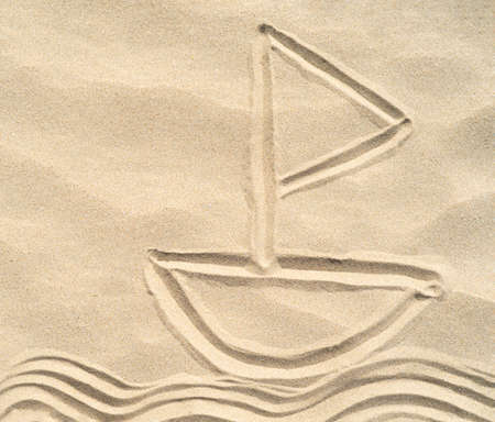 A ship drawn on the sand. Texture of sea sand background closeup with ornamentの写真素材