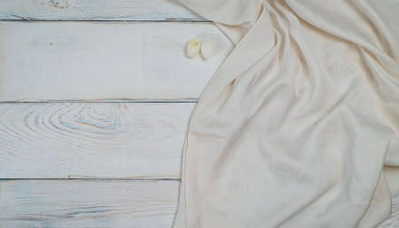 White silk fabric on white wooden background with copy spaceの写真素材