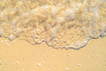 Sand with stones and sea water top view backgroundの写真素材
