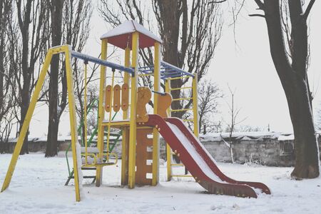 Winter playground kids. Snow in the street. Winter holiday.