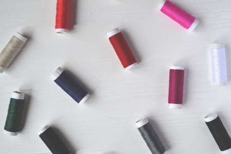 Colorful thread coils on the white background.の写真素材