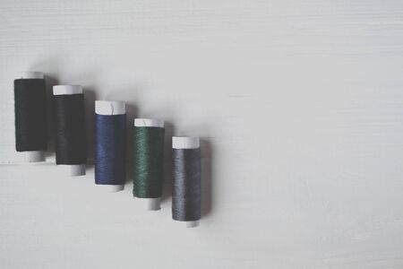 Coolorful thread coils on the white background with place for text.の写真素材