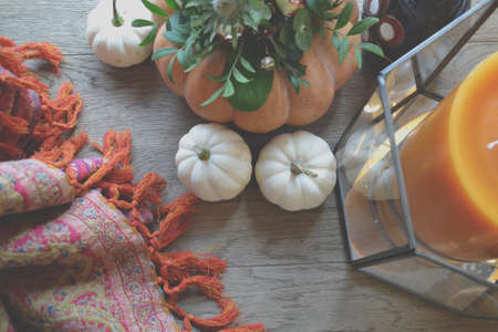 Pumpkins on the table. Flower composition. Home decoration. Atmospheric photo.の写真素材