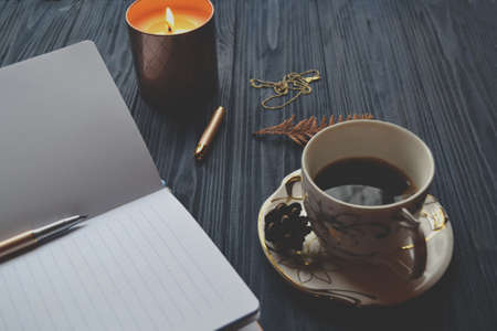 Vintage objects and a cup of coffee on the wooden table. Atmosphere of relax, dream, art or work.の写真素材