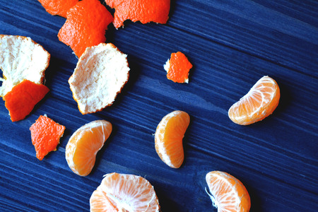 Tangerine on the table. Mandarin orange on the wooden background. Healthy food on the dark blue background.の写真素材