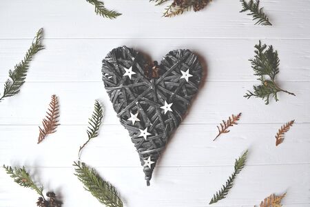 Decoration on the white table. Hand made heart on the white wooden table. Vintage background.の写真素材