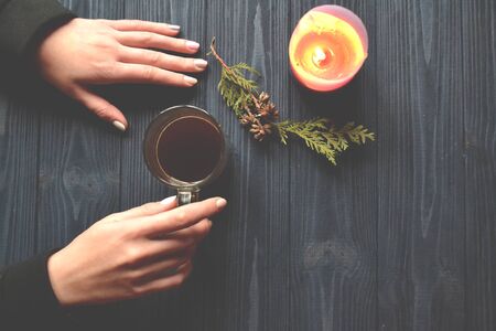 Woman holding a cup of coffee in her hands.