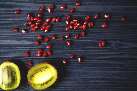 Garnet and kiwi fruits on the table. Healthy food. Useful fruits.