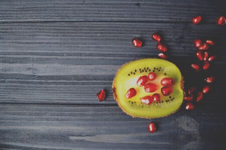Garnet and kiwi fruits on the table. Healthy food. Useful fruits.の写真素材