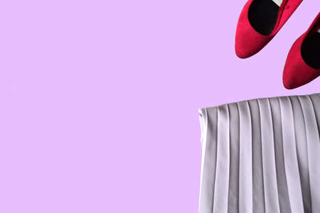 Elements of style. Shoes and cloth on the pink background.