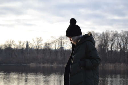 Woman relaxing near the river.の写真素材