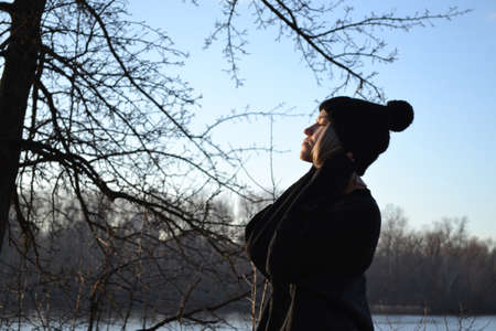 Woman relaxing near the river.の写真素材