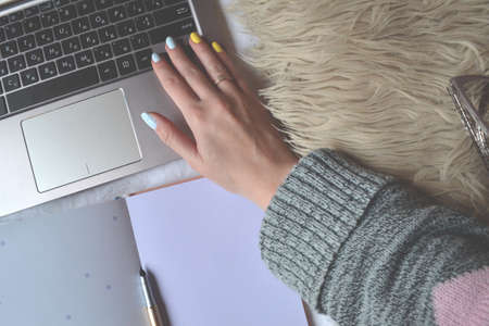Work at home. Cozy place for freelance work. Freelancer's workplace. Woman working on a laptop.の写真素材