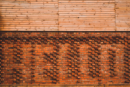 Creative brick wall. Brown wooden background.