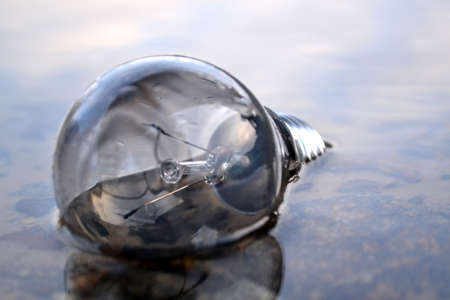 Light bulb in the water. Electricity lamp.