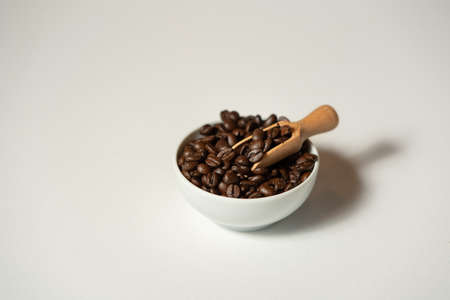 A white bowl with bean coffee on the white backgroundの写真素材
