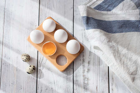 white chicken eggs on gray wooden table. flat lay