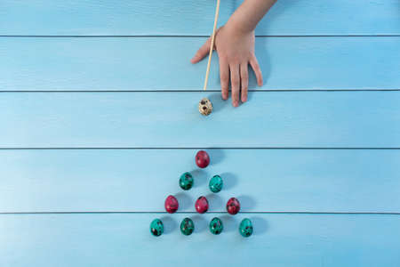 red and blue quail eggs in the shape of a triangle for billiards, bowling on blue backgroundの写真素材