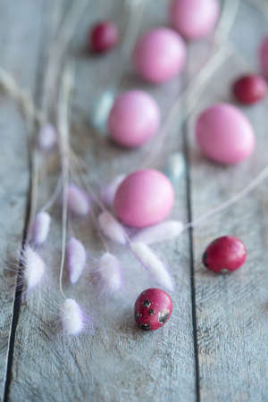 pink easter eggs on gray wooden table. background. card.