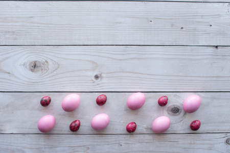 pink eggs on a gray wooden table. Mimimai. Card with space for text.の写真素材