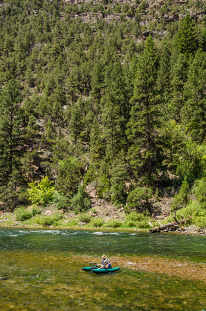 Mountain River, a fisherman in a boatのeditorial素材