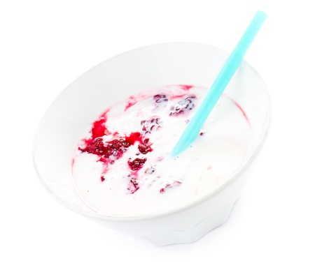 Fresh yogurt with  blackberry in a white bowl with straw, isolatedの写真素材
