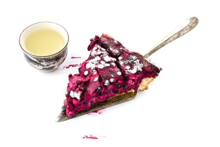 A piece of blueberry pie with cup of tea isolated on white backgroundの写真素材