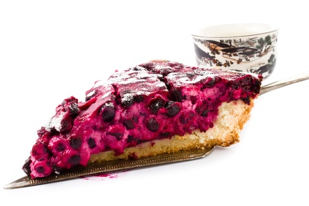 A piece of blueberry pie and cup of tea isolated on white backgroundの写真素材