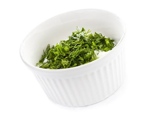 Sour cream in small round plate with herbs, isolatedの写真素材
