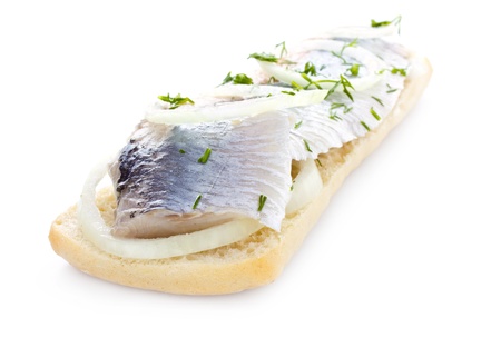Sandwich with herring, onions and herbs, isolatedの写真素材