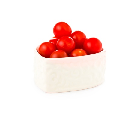 fresh tomatos in a heart shape isolated on white backgroundの写真素材