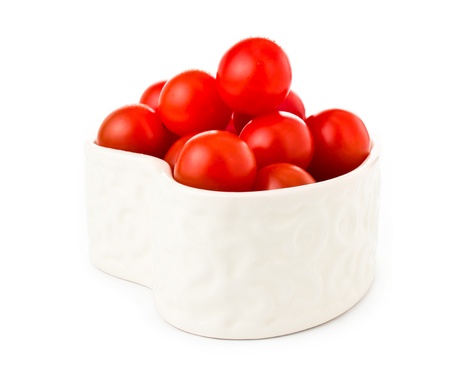 fresh tomatos in a heart shape isolated on white backgroundの写真素材
