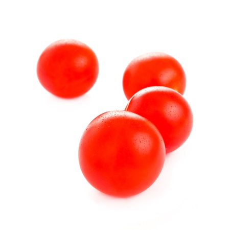 cherry tomatoes isolated on white backgroundの写真素材