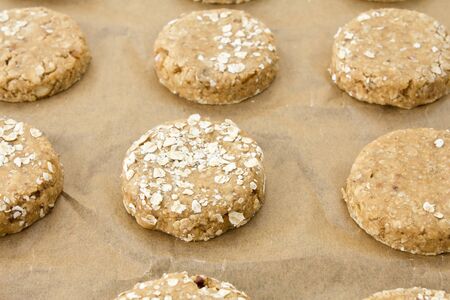 Raw oatmeal cookie dough on a baking sheet with parchmentの写真素材
