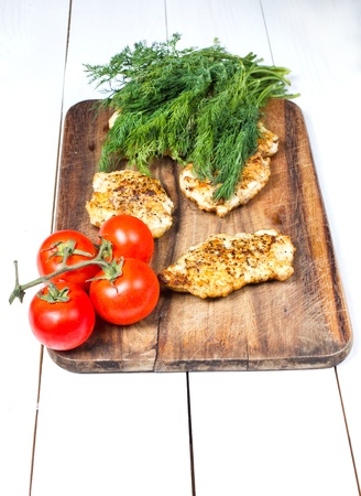 Grilled chicken breasts fillet with fresh vegetablesの写真素材