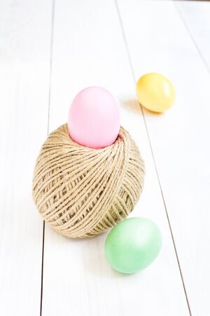 Easter egg and rolling ball of hemp rope on wooden backgroundの写真素材