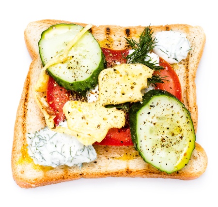 Fresh toast with bread, fried fresh eggs, vegetables and cream, isolated on white background, closeupの写真素材
