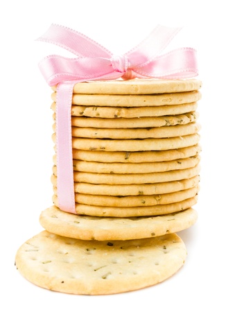 Festive wrapped with pink ribbon fresh pastry cookies isolated on white backgroundの写真素材