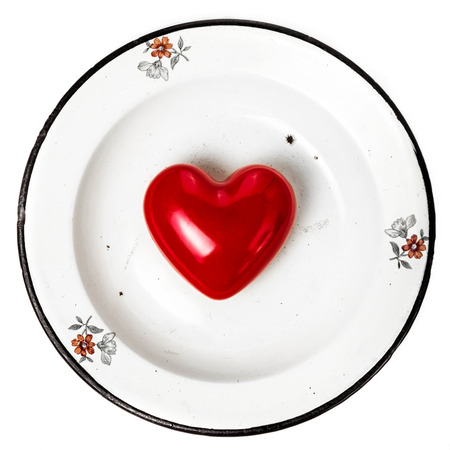 Valentines Day background with Red Hearts on vintage plate with copy space for text isolated on white background. Love and Valentines day concept.の写真素材