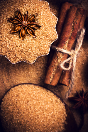 Baking ingredients Cinnamon sticks,  star anise and cane brown sugar close up.の写真素材