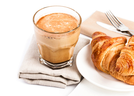 Breakfast with  Croissants  and Coffee on a white plate and linen tablecloth isolated on white background, closeup.の写真素材