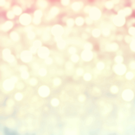 Golden Abstract Christmas background with glowing magic bokeh and snow flakes, defocused holiday lights with copyspace の写真素材