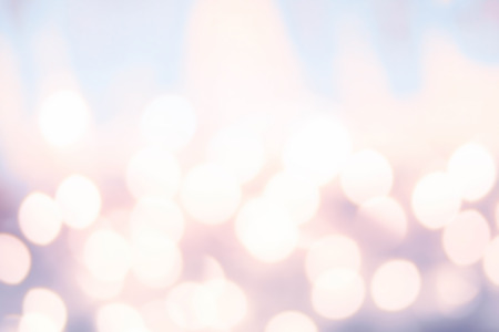 Defocused Bokeh twinkling lights background. Colorful   Abstract twinkled  bright golden festive background, soft pink and red colors.
の写真素材