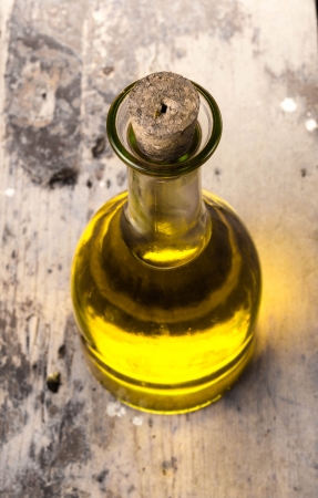 Olive oil in a bottle on  rustic  dark tableの写真素材