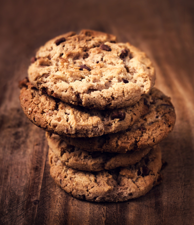 Chocolate chip cookies on wooden background. Stacked chocolate chip cookies shot with selective...