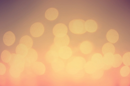 Gold Festive sunrise background. Bright abstract Christmas background with glowing bokeh.