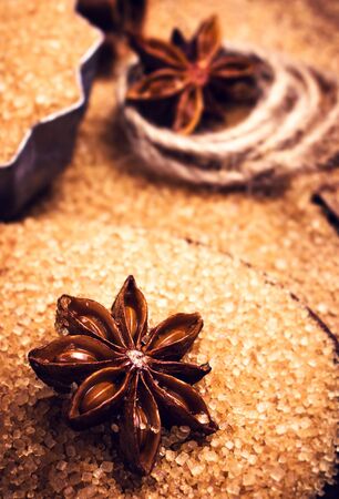 Cinnamon sticks and star anise on brown sugar macro. Christmas spices for holiday bakingの写真素材