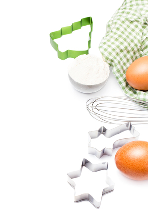 Festive cookie cutters,  eggs and flour for baking cookies isolated on white background. の写真素材