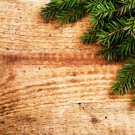 Christmas with Fir Tree Branch on wooden with copy space for greeting text. Christmas Card.