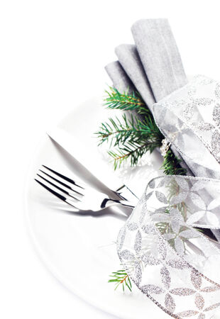 Christmas card with Fir Tree Branch and Christmas table place setting with christmas ornaments and copy space for text on white plate  isolated on white の写真素材